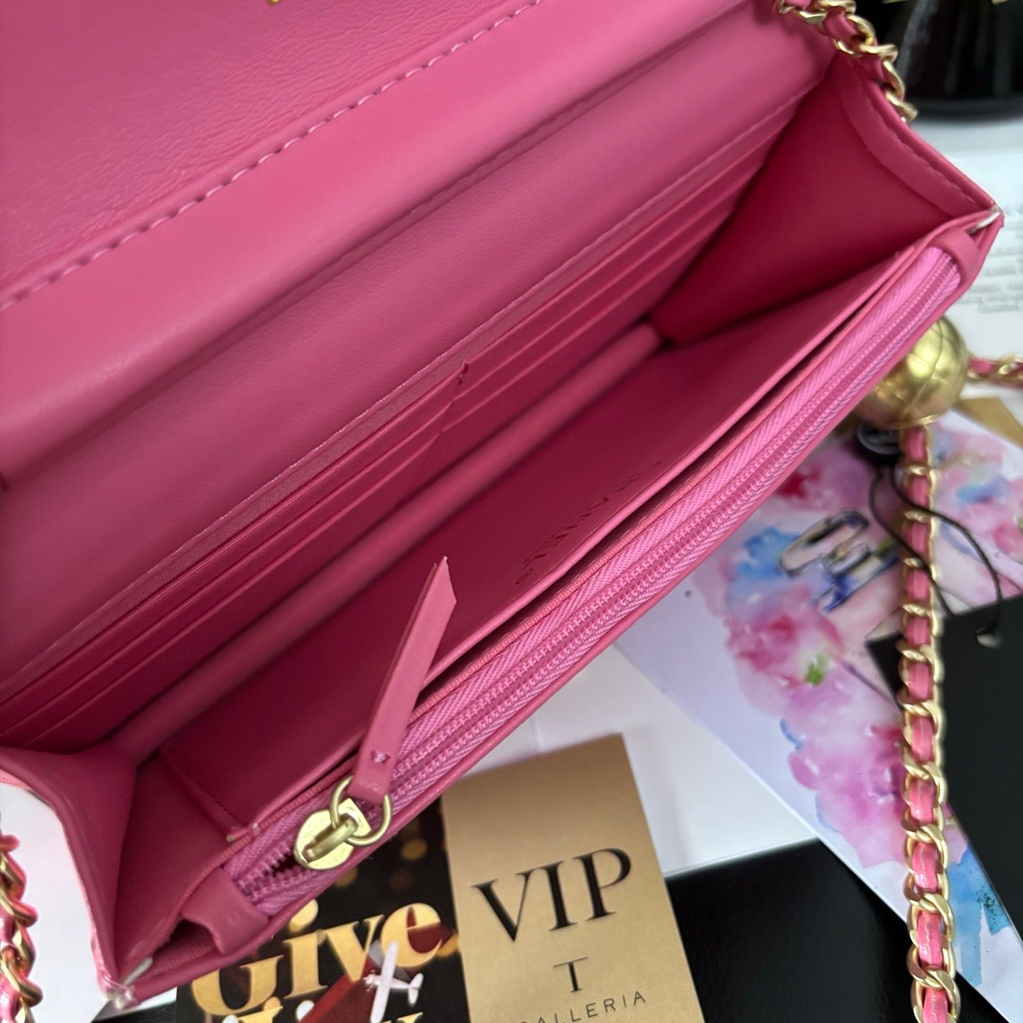 Pink handbag with gold chain inside