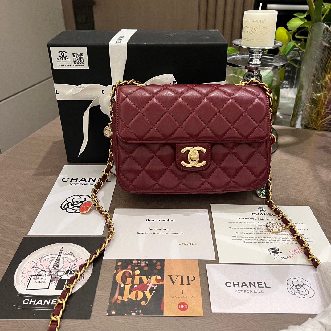 Maroon quilted handbag with gold chain and Chanel vip makeup packaging 
